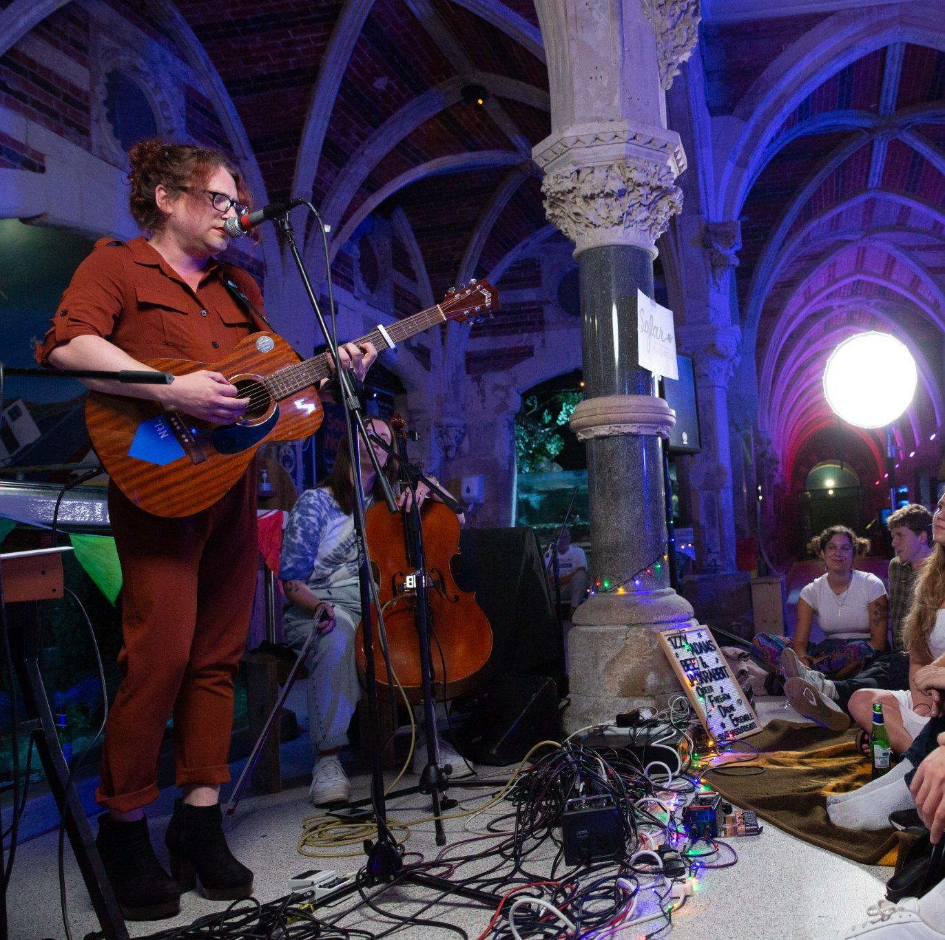 With a cellist in a vaulted venue